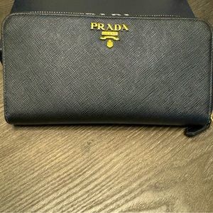 Large black Prada wallet in saffiano leather with red interior